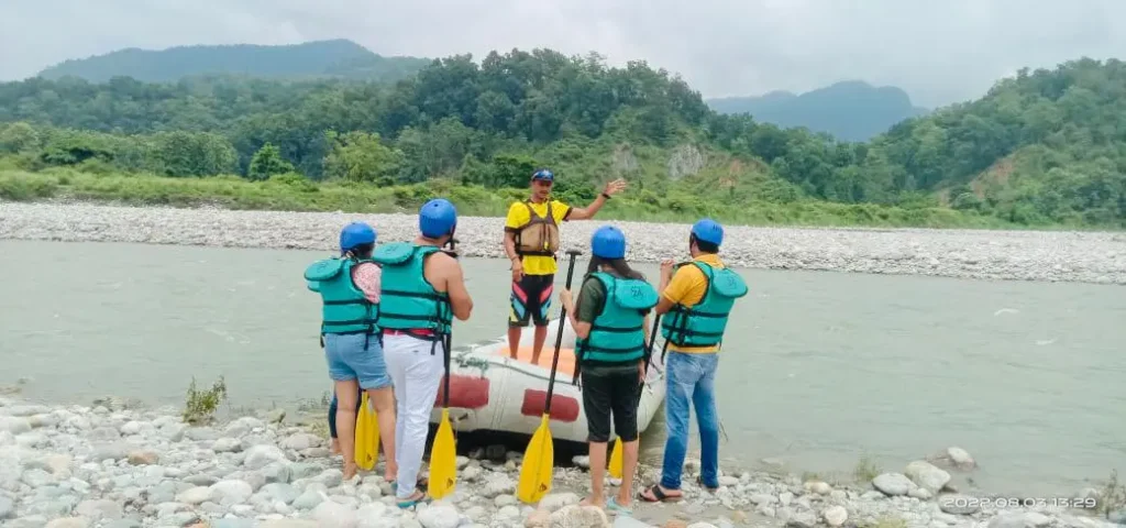 Rafting guide instructing a team